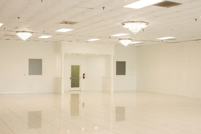 Spacious hall with banquet tables and chandelier lighting