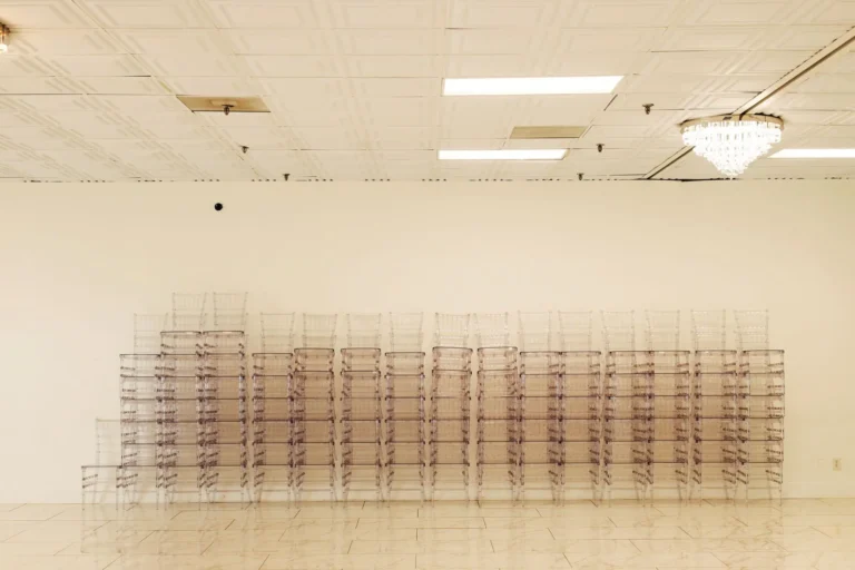 Spacious hall with banquet tables and chandelier lighting